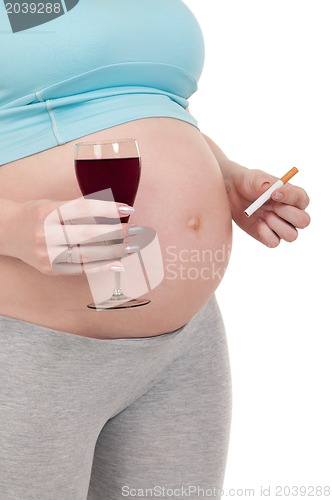 Image of Pregnant belly with wine and cigarettes