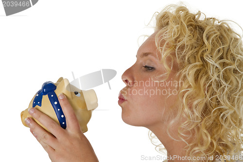 Image of Young woman kissing big piggy bank