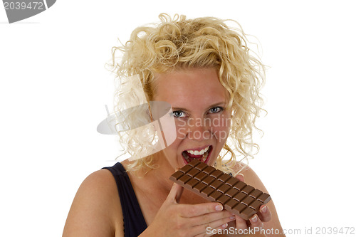 Image of Young woman eating chocolate