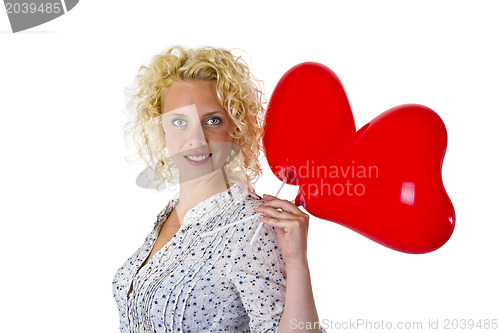 Image of Young woman holding heart ballons
