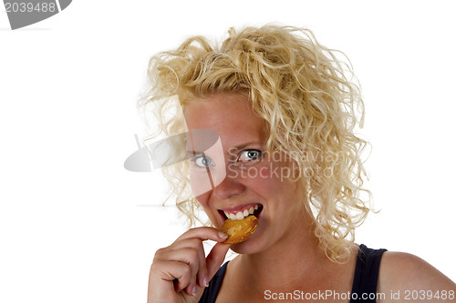 Image of Young woman eating cookie