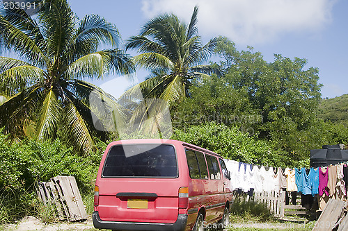 Image of residential street scene van with laundry hanging palm  trees Cl