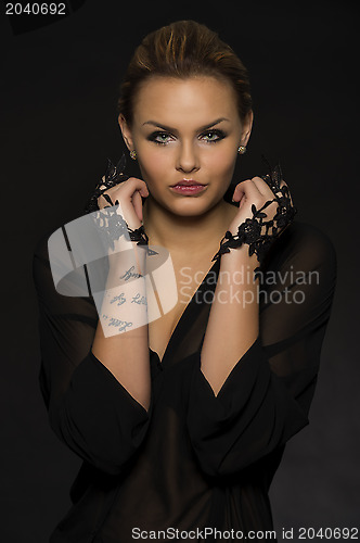 Image of Glamorous woman in black evening wear