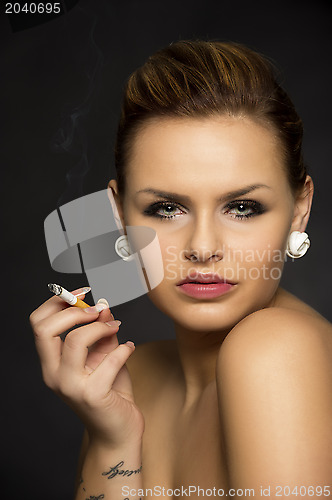 Image of Beautiful seductive woman smoking