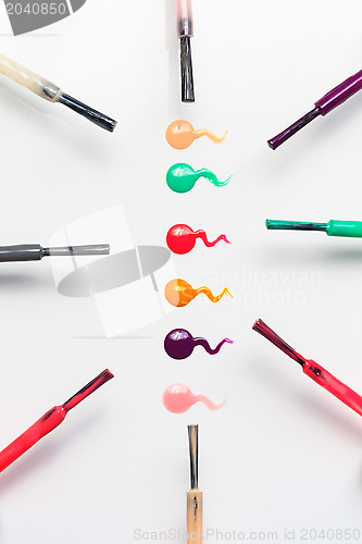 Image of Set of multicolored nail polish brushes and drops