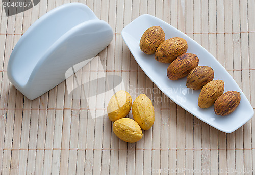 Image of nuts on a plate next to the napkin