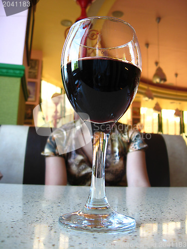Image of Glass of wine and the girl at restaurant