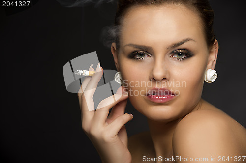 Image of Stylish woman smoking a cigarette