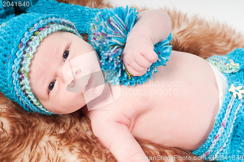 Image of Newborn baby in long blue knitted hat