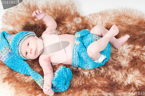 Image of Newborn baby in long knitted hat