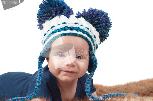 Image of Cute baby in knitted hat with big pom-pons