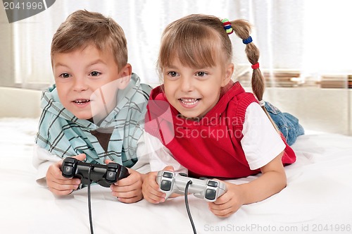 Image of Happy girl and boy playing a video game