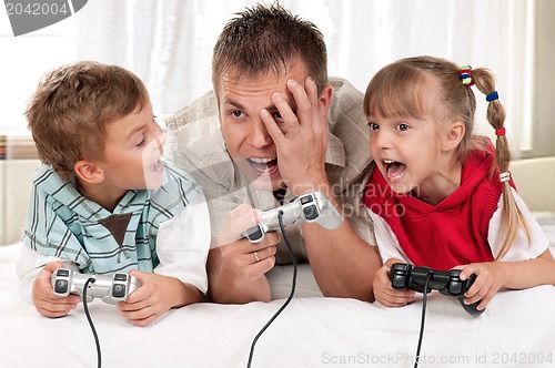 Image of Happy family playing a video game