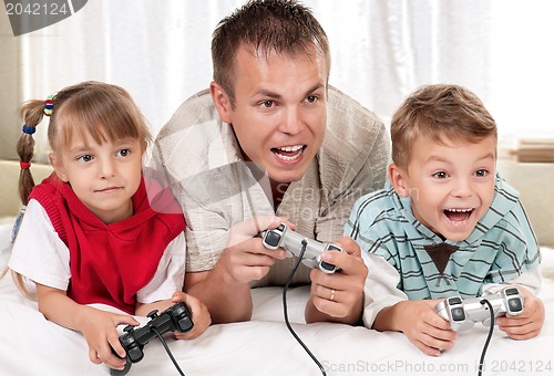 Image of Happy family playing a video game