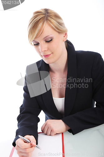 Image of Young businesswoman writing notes