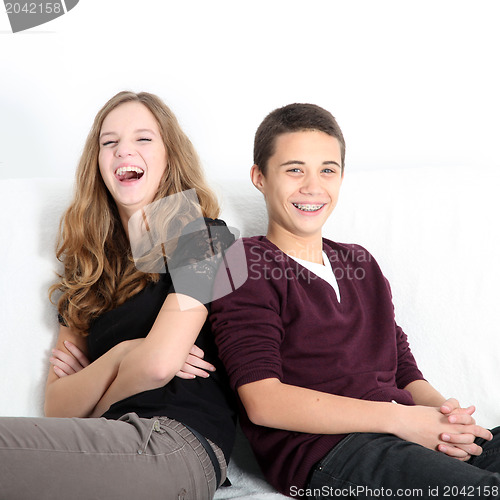 Image of Laughing teenaged brother and sister