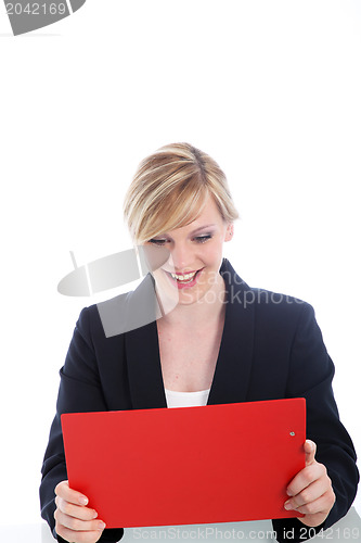 Image of Elated woman reading notes on a clipboard