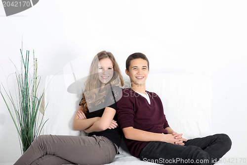 Image of Teenaged couple relaxing at home
