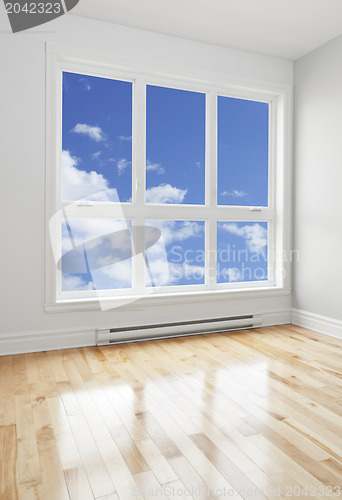 Image of Empty room and blue sky seen through the window
