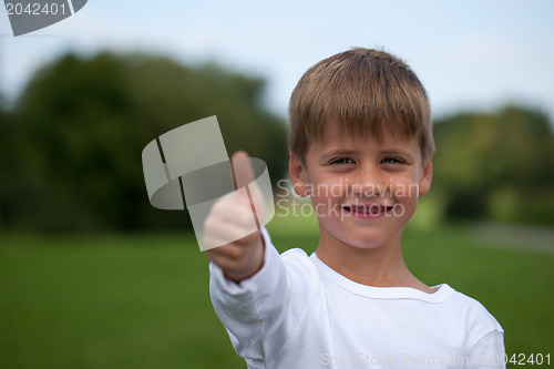 Image of Little boy showing thumbs up