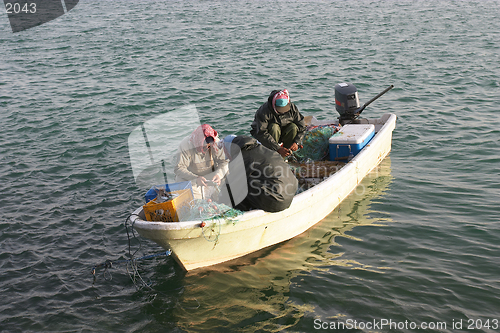 Image of Three men in a boat