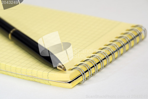 Image of Black ballpoint pen and notebook 