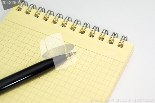 Image of Notebook and ballpoint pen