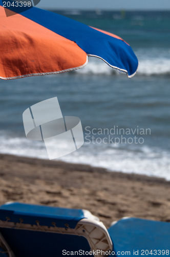 Image of Sunchair And Umbrella On The Beach