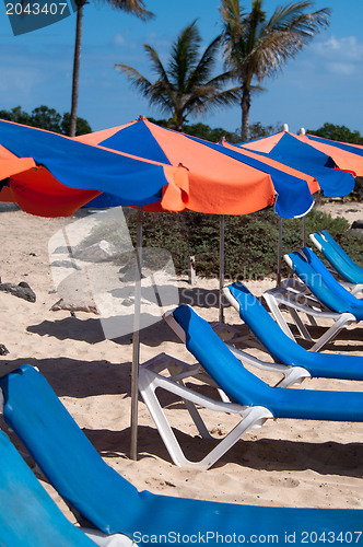 Image of Sunchairs And Umbrellas On The Beach