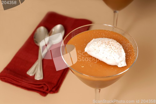 Image of Two butterscotch puddings with whipped cream