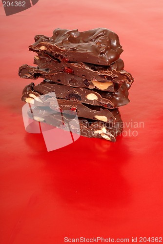 Image of Chocolate cashew and dried cherry bark on a red background