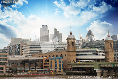 Image of City of London with clouds, financial center and Canary Wharf at