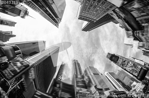 Image of Upward fisheye view of tall skyscrapers against a blue sky in th