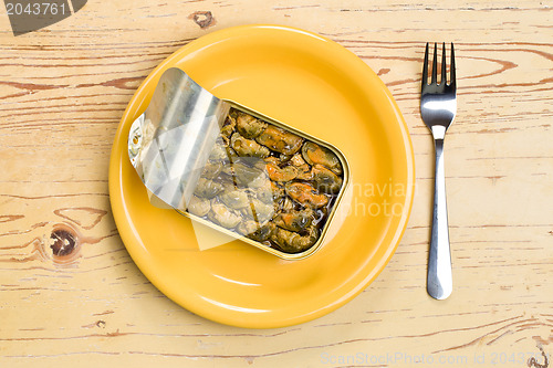 Image of smoked mussels in opened tin can