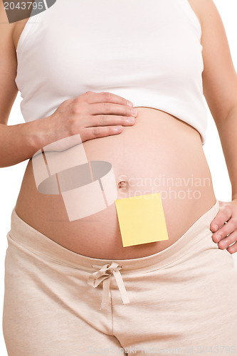 Image of pregnant women with notepaper on her belly