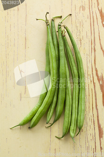 Image of bean pods on wooden table