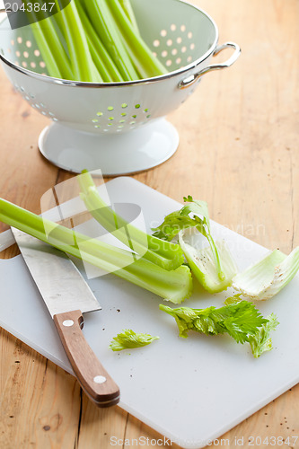 Image of green celery sticks on kitchen table