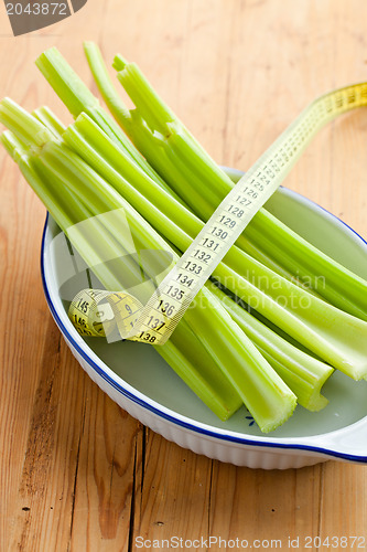 Image of green celery sticks on kitchen table