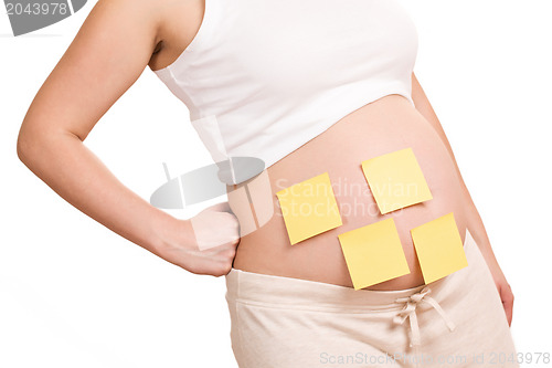 Image of pregnant women with notepaper on her belly