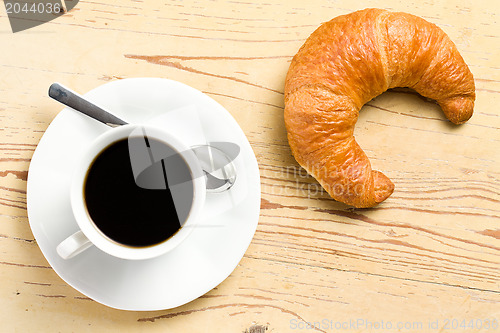 Image of fresh croissant with coffee