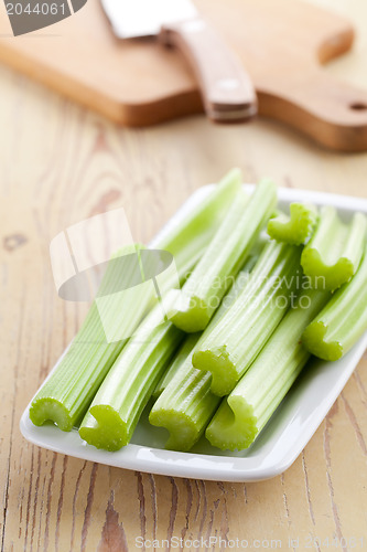 Image of green celery sticks on kitchen table