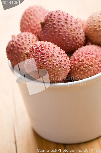Image of tasty litchi fruit in ceramic bowl