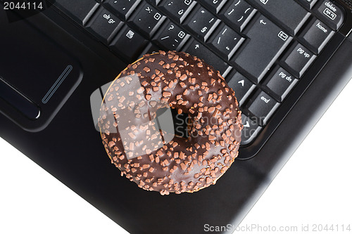 Image of break in the  office . doughnut on laptop keyboard