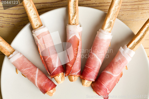 Image of grissini sticks with ham