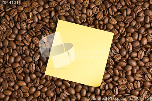 Image of yellow note paper on coffee beans background