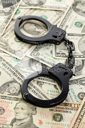 Image of handcuffs on dollars