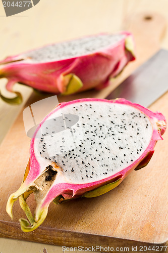 Image of pink pitahaya on wooden table