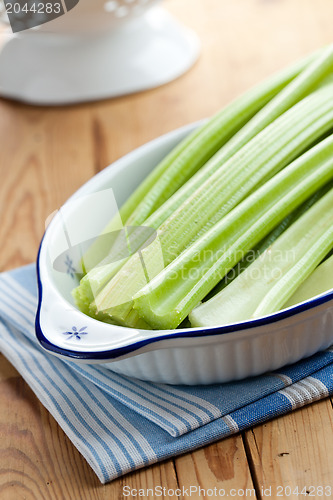 Image of green celery sticks on kitchen table