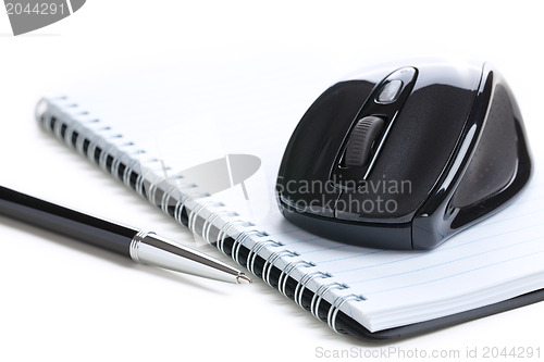 Image of computer mouse and notebook with pen