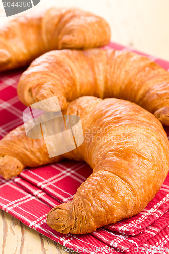 Image of fresh croissants on checkered napkin